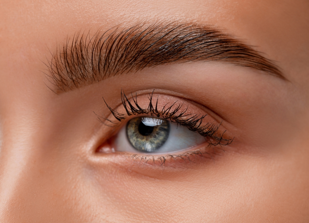 A close up of a woman's eye brow after getting a procedure done 